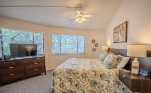 a bedroom with a bed and a flat screen tv at Lakefront Bungalow with Community PoolHot Tub #1 in Lakeway +14 photos