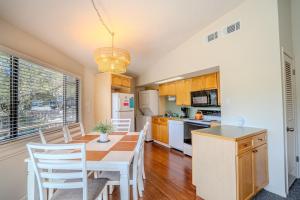 a kitchen and dining room with a table and chairs at Lakefront Bungalow with Community PoolHot Tub #1 in Lakeway