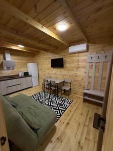 a room with a kitchen and a table in a cabin at Hotel Voyage Вояж in Uman