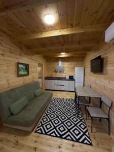 a living room with a couch and a table at Hotel Voyage Вояж in Uman