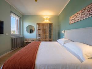 a bedroom with a large bed and a window at My Tuscany Green Apartment in San Quirico dʼOrcia