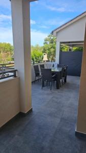 a patio with a table and chairs on a balcony at Villa DARIAN in Sukošan