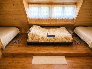 a bedroom with a bed in a room with a window at Magiczny Dom nad Bugiem in Pętkowo Wielkie