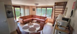 a living room with a couch and a table at Maxent aan zee in Middelkerke