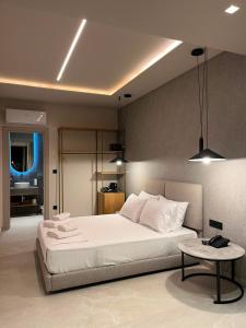 a bedroom with a large white bed and a table at SunSet Boutique Hotel in Neos Marmaras +96 photos