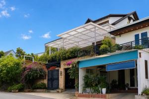 a building with plants on the side of it at AT House Dalat - The Pine Concept in Da Lat