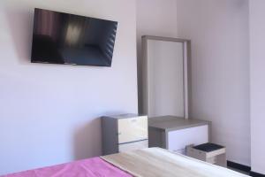 a bedroom with a bed and a tv on the wall at Madu Rivora Villa in Ambalangoda +42 photos