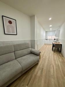 a living room with a couch and a table at URDAIHOME SUITES & BIKEs in Guernica y Luno
