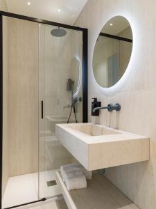 a bathroom with a sink and a mirror and a shower at Palazzo Settanta in Catania +75 photos