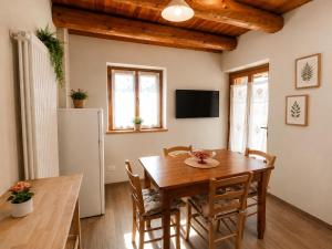 a dining room with a wooden table and chairs at Appartamento Alta Valle Maira - Tibert in Ponte Maira