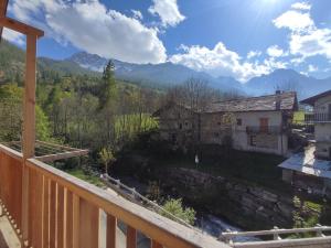 a balcony with a view of a house and mountains at Appartamento Alta Valle Maira - Tibert in Ponte Maira