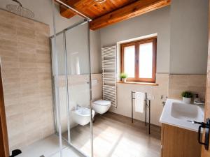 a bathroom with a shower and a toilet and a sink at Appartamento Alta Valle Maira - Tibert in Ponte Maira