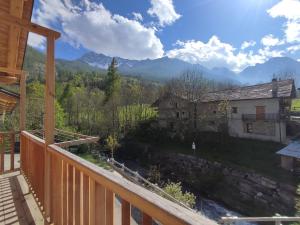 a view from a balcony of a house and a river at Appartamento Alta Valle Maira - Tibert in Ponte Maira +4 photos