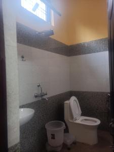 a bathroom with a toilet and a sink at Shivalik restaurent and hotel in Kālādhūngi