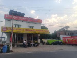 a building with signs on the side of a street at Shivalik restaurent and hotel in Kālādhūngi