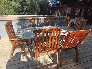 a wooden table and chairs on a deck at Chalet Les Buis in Saint-Paul-lès-Romans