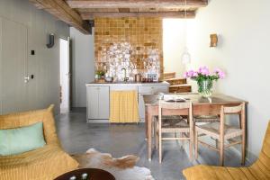 a kitchen with a table and a dining room at Walingsuites in Holwerd