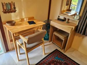a table and a chair in a room with a mirror at Blue Cottage Koh Kood a Quiet Tropical Getaway in Ban Lak Uan