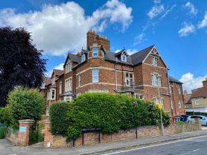 a large brick building with a chimney on a street at Noa Residence in Oxford