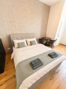 a bedroom with a large bed and a table at City Apartment 1 in Vienna