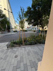 a city street with a park with flowers and trees at City Apartment 1 in Vienna