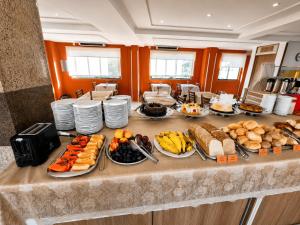 a buffet with many different types of food on a table at Lebanon Praia Hotel in Tramandaí