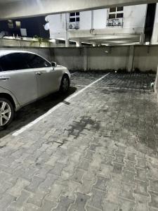 a white car parked in a parking lot at Luimora Stays in Bamgbose