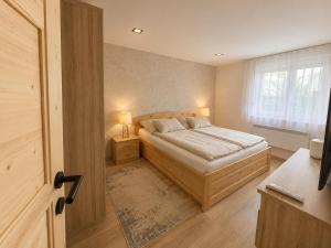 a bedroom with a bed and a window at Wendell Apartman in Nyíregyháza +31 photos