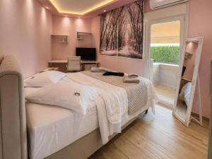 a bedroom with a white bed and a window at GF Luxury Villa with indoor pool -Afytos in Afitos +31 photos