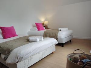 a bedroom with two beds and a suitcase in the middle at La Maison du Petit Port in Nantes