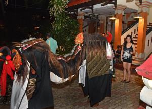 a woman is standing next to a horse costume at Puri Naga Beachfront Cottages in Legian +102 photos