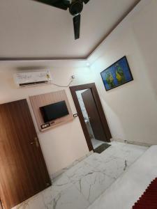a room with a door and a microwave on the wall at Kailashi Hotel Har ki pauri in Haridwār