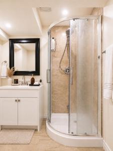 a bathroom with a shower and a sink at Chic & Spacious 2BR Home Near Yonge St in Newmarket +23 photos