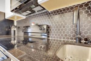 a kitchen with a sink and a stove at The Neuschwanstein Flat- Walkable in Columbus +19 photos