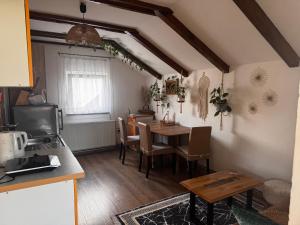 a kitchen with a table and a dining room at Apartments Aida in Bihać +25 photos
