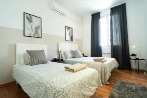 a bedroom with two beds and a window at Magdalena2 Street, Private rooms in Madrid