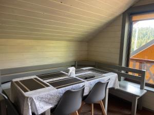 a dining room with a table and chairs in a room at Вовкаль in Yablunytsya +19 photos