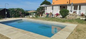 a swimming pool in front of a house at Joka B&B e Home Food in Potenza Picena