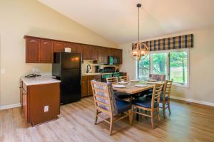a kitchen and dining room with a table and chairs at The Summit at Massanutten Resort by TripForth in McGaheysville