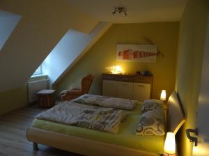 a bedroom with a bed and a staircase at Darssblick Barth - Boddenblick, Tiefgarage & Aufzug in Barth