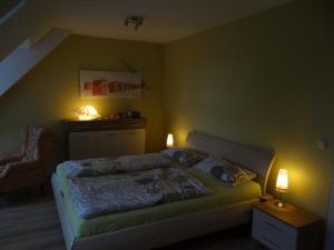 a bedroom with a bed and a staircase with lights at Darssblick Barth - Boddenblick, Tiefgarage & Aufzug in Barth