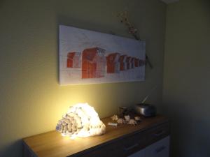 a light on top of a dresser in a room at Darssblick Barth - Boddenblick, Tiefgarage & Aufzug in Barth