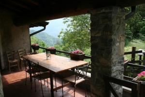 a table and chairs on a porch with a view at Chalet Calcar in Avenone