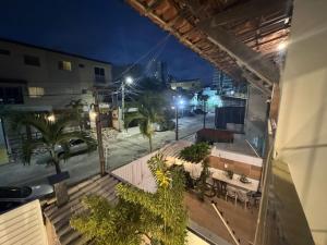 a view of a street at night from a balcony at Espaço rosa mar in Aracaju
