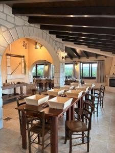 a large dining room with wooden tables and chairs at Le Zarafe in Caltabellotta