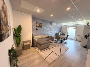 a living room with a couch and a table at Hugo s home, apartman blizu bazena i bolnice in Krapinske Toplice +1 photo