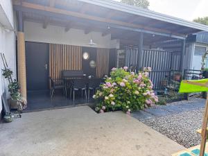 a patio with a table and chairs and flowers at Apartments Aida in Bihać
