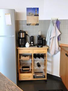 a kitchen with a counter and a refrigerator at Traumblick Barth - Boddenblick, Tiefgarage & Aufzug in Barth