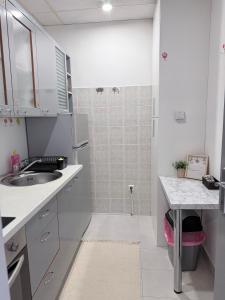 a small white kitchen with a sink and a shower at Hugo s home, apartman blizu bazena i bolnice in Krapinske Toplice