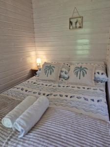 a bed in a room with two pillows on it at Holiday Resort Zakątek Łeba in Łeba